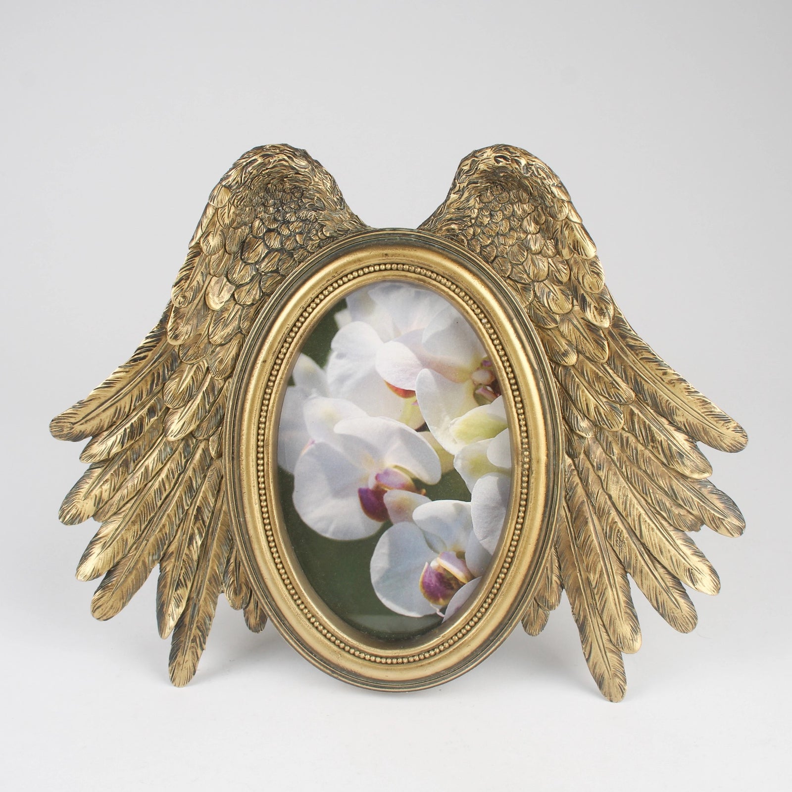 Gold winged frame with a floral image on a white background