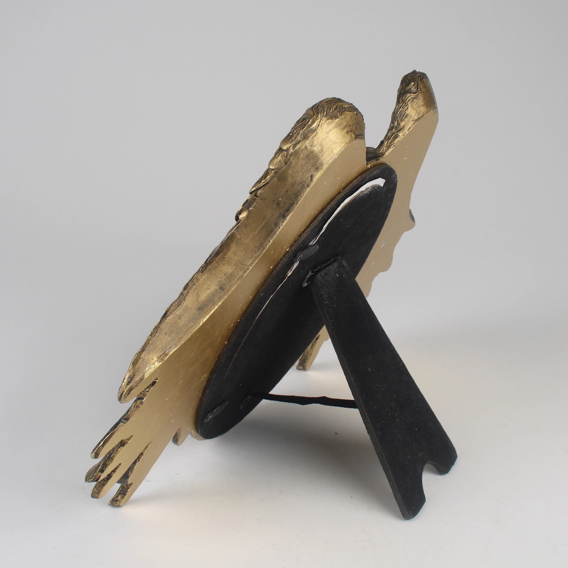 Side view of Decorative photo framet with gold and black design on a white background