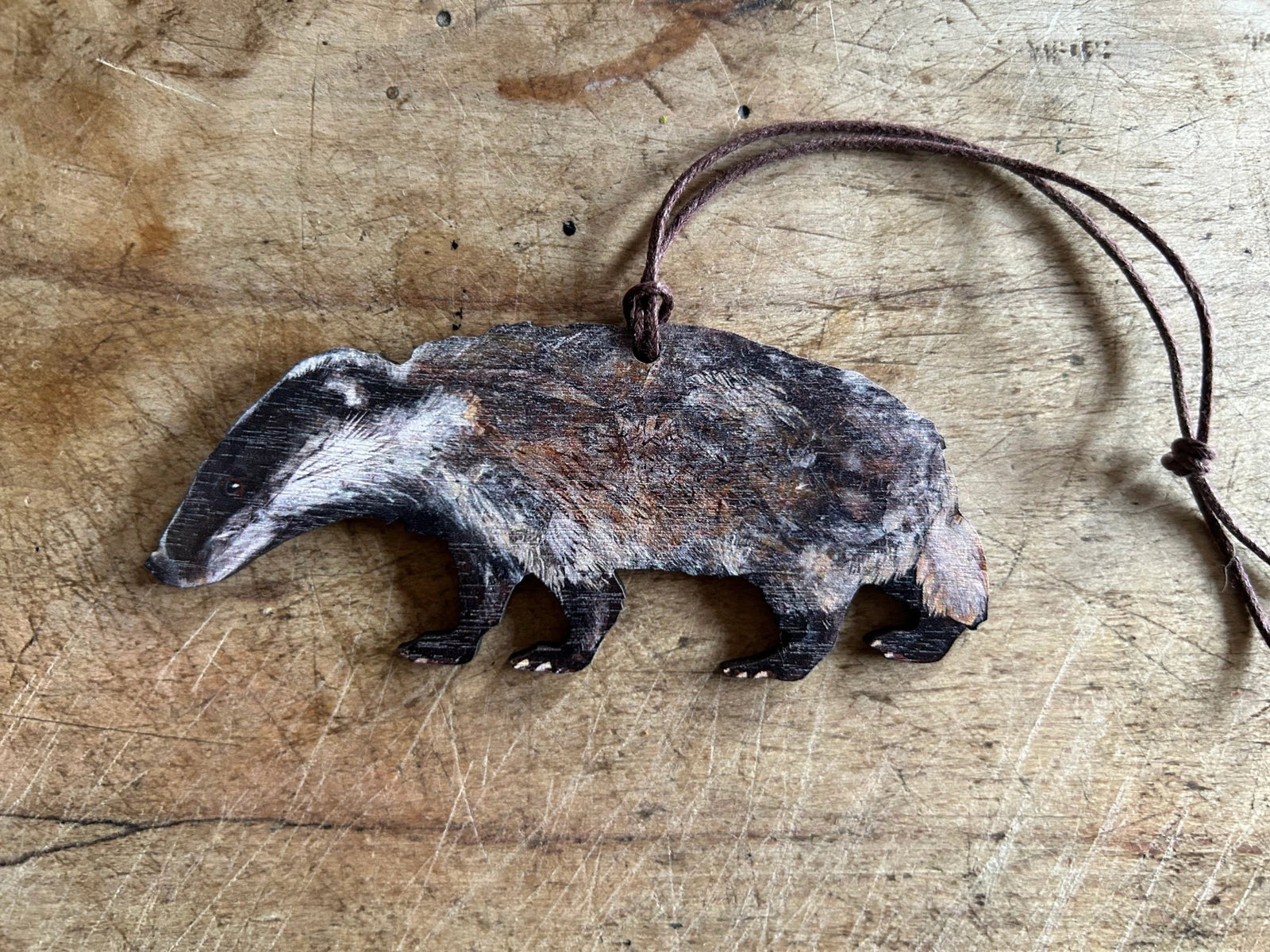 Wooden badger hanging decoration on wooden surface