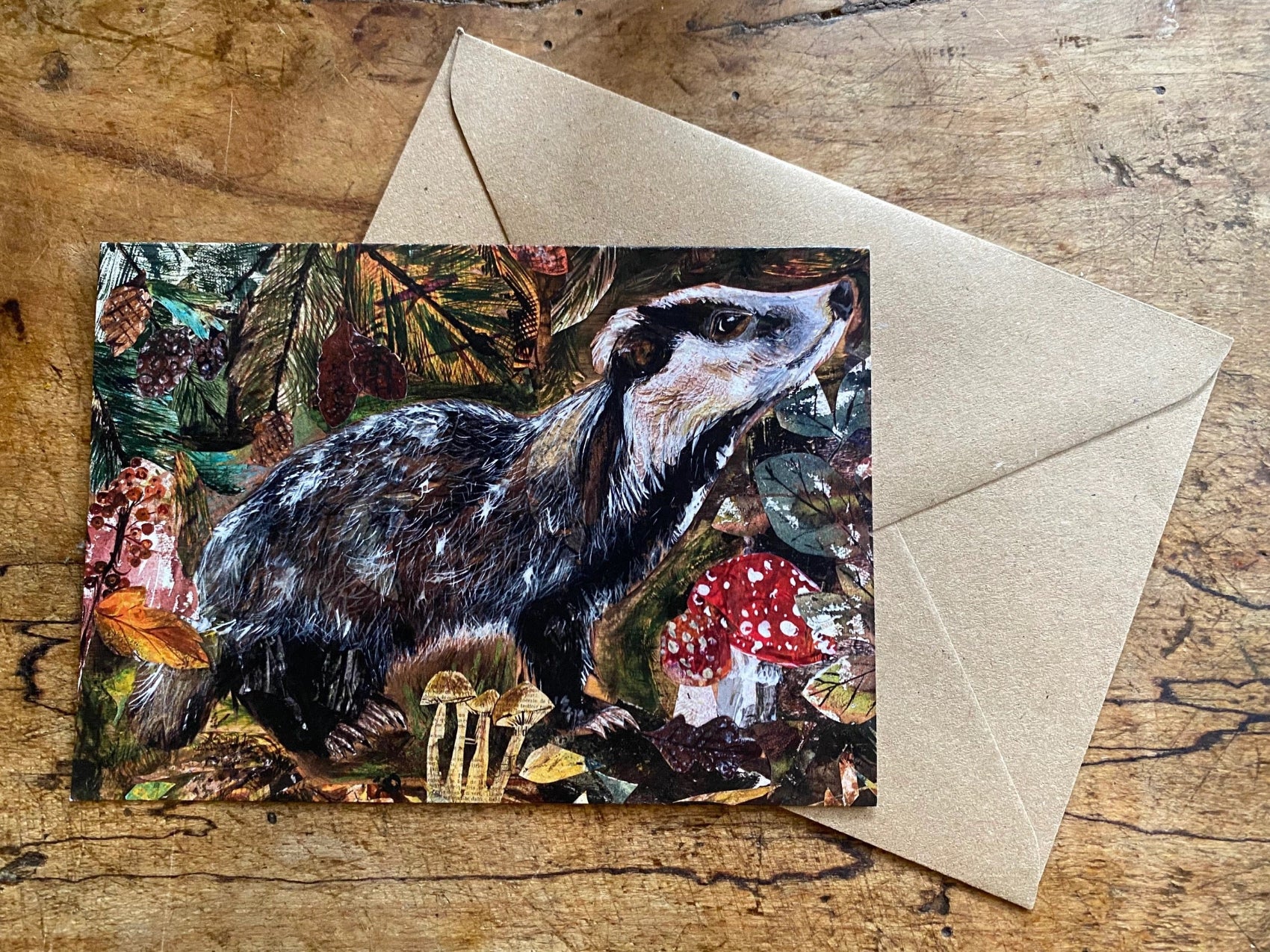 Greeting card with a badger illustration shown on a wooden surface