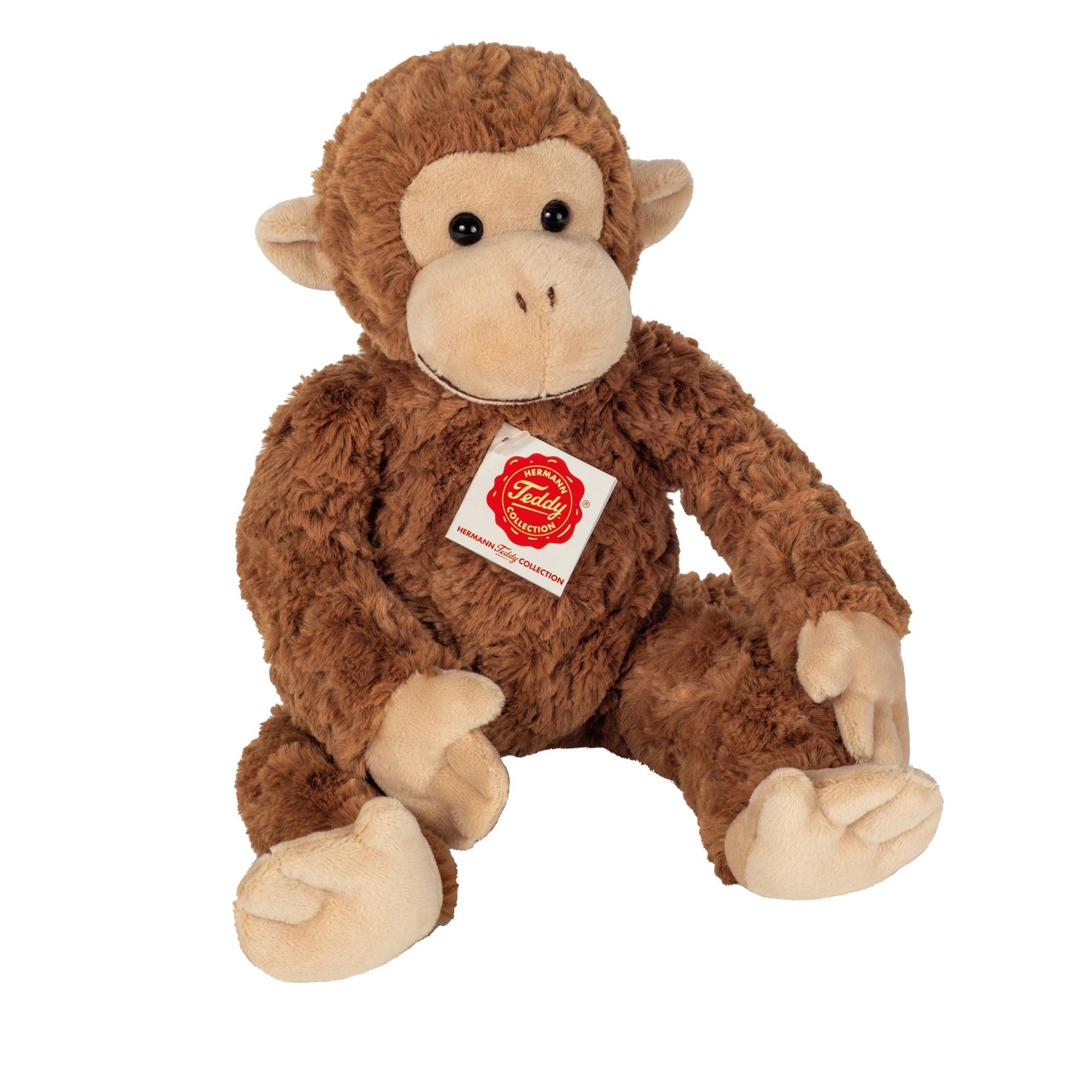 Plush monkey toy with a visible brand label on a white background