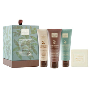 Gardener's Hand Therapy product set including a box, three tubes, and a bar of soap on a white background.