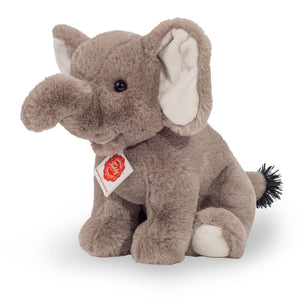 Plush elephant toy with a visible tag on a white background