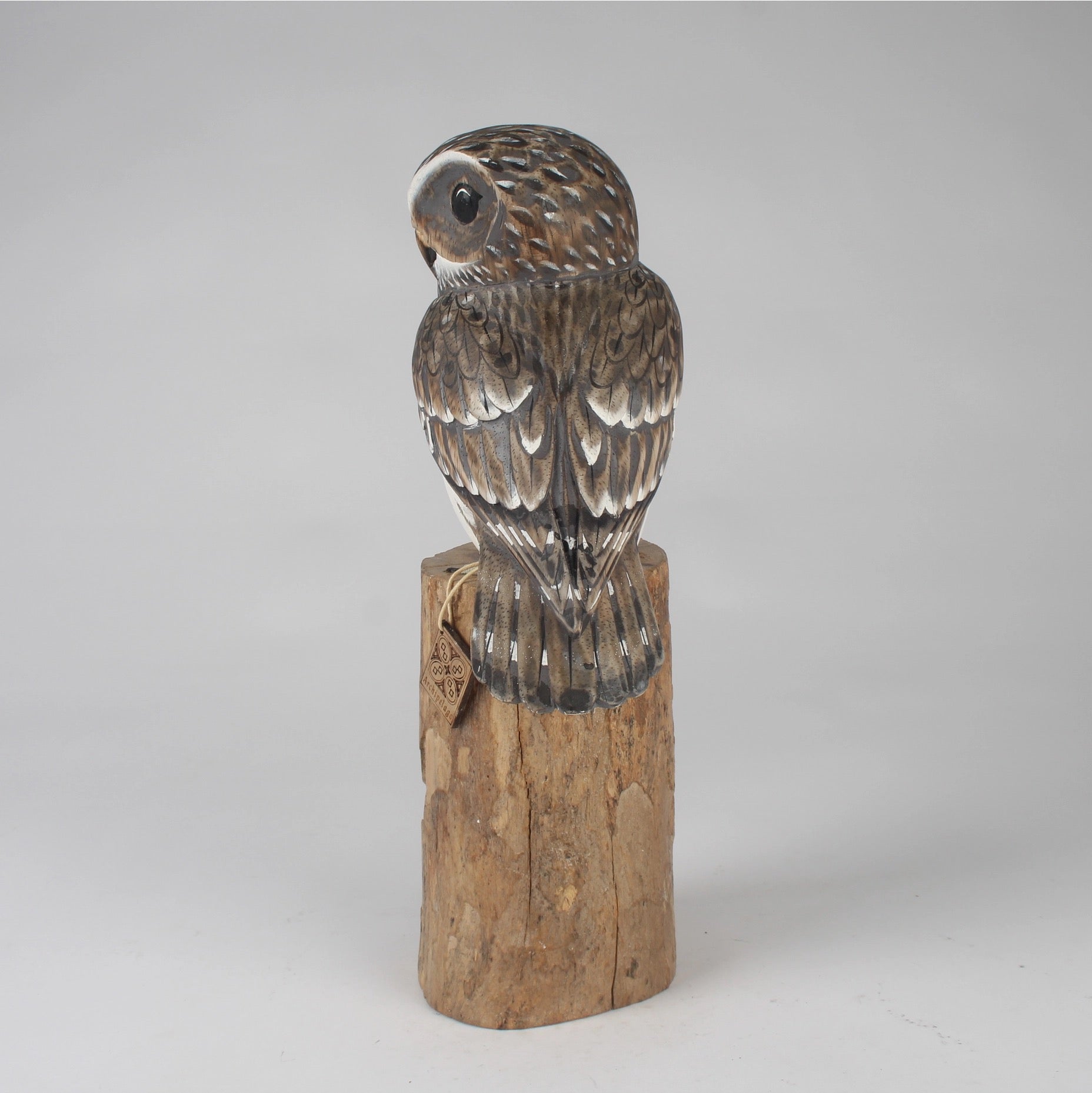 Wooden owl Sculpture on a gray background