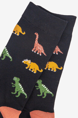 Black socks with colorful dinosaur pattern on a white background
