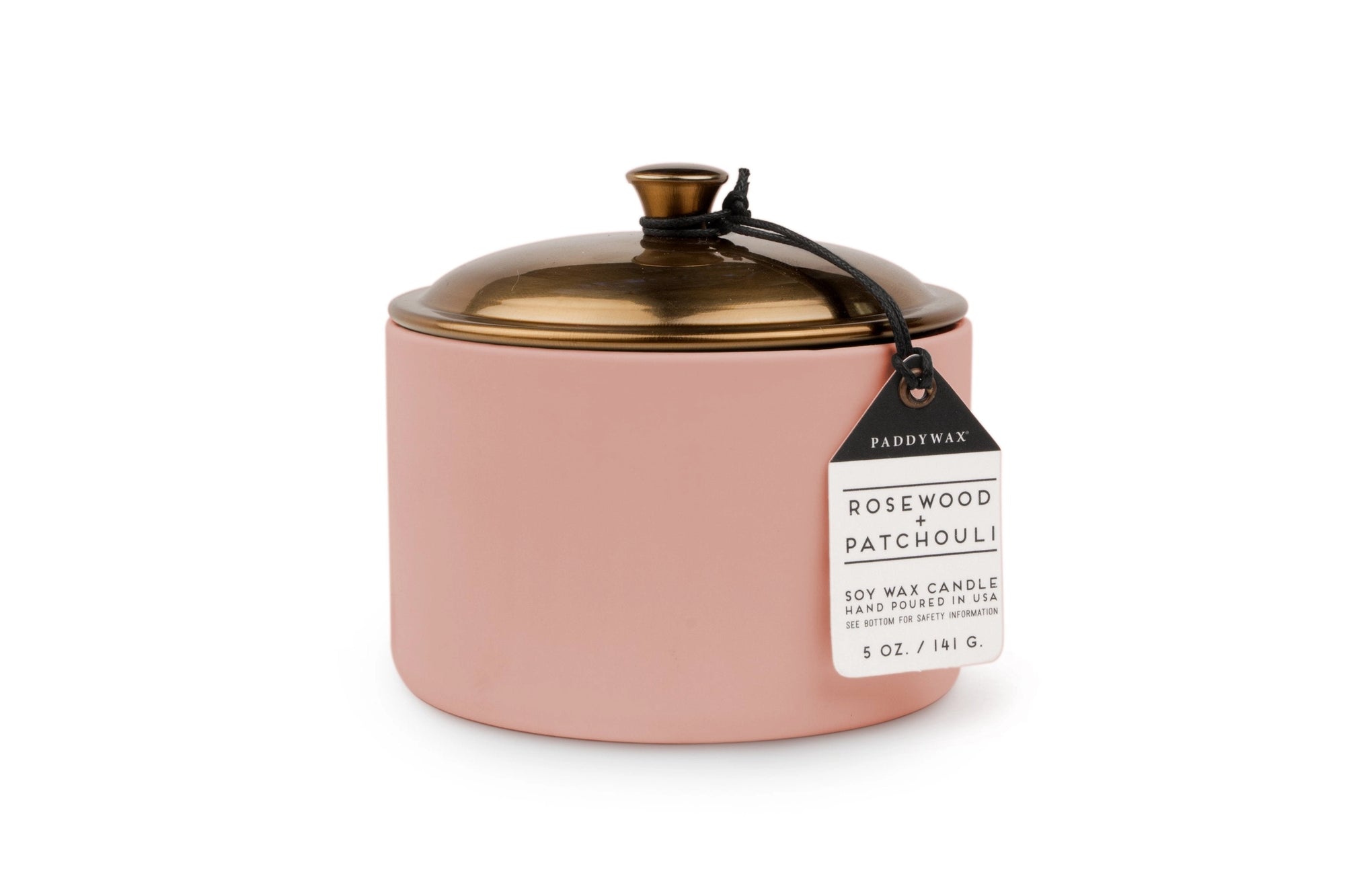 Pink candle with a copper coloured  lid and label on a white background