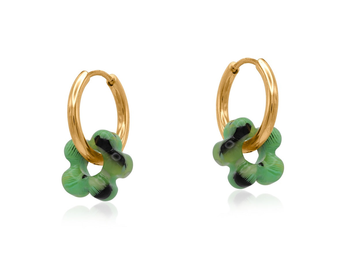 Gold hoop earrings with green and black floral designs on a white background