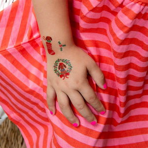 A childs hand showing a sausage dog tattoo