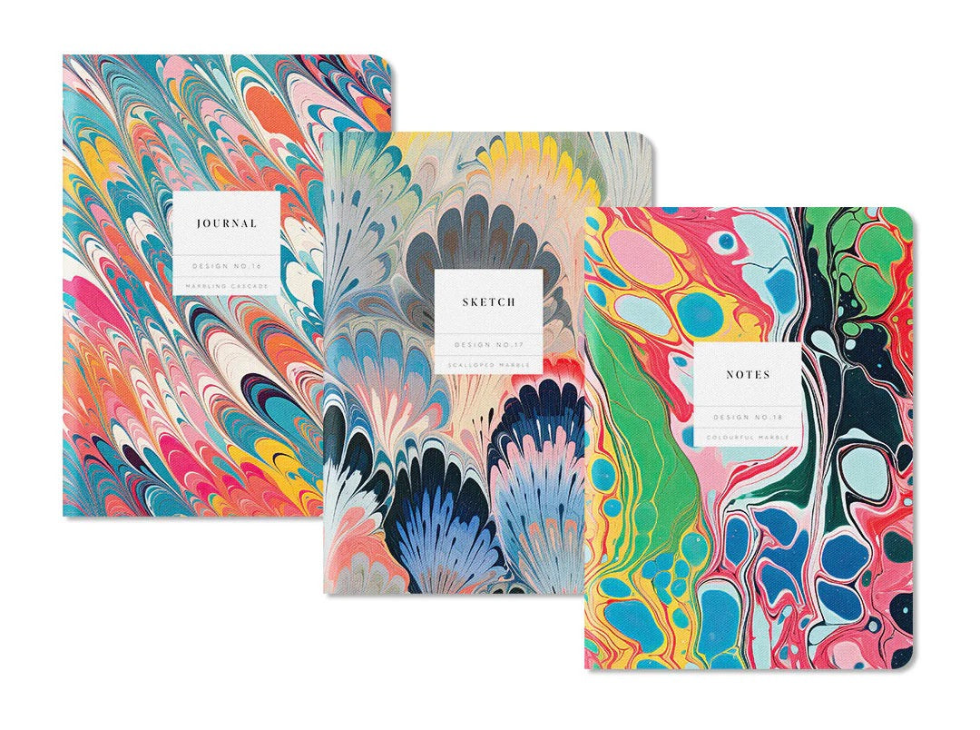 Three colorful notebooks with marbled designs on a white background