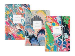 Three colorful notebooks with marbled designs on a white background
