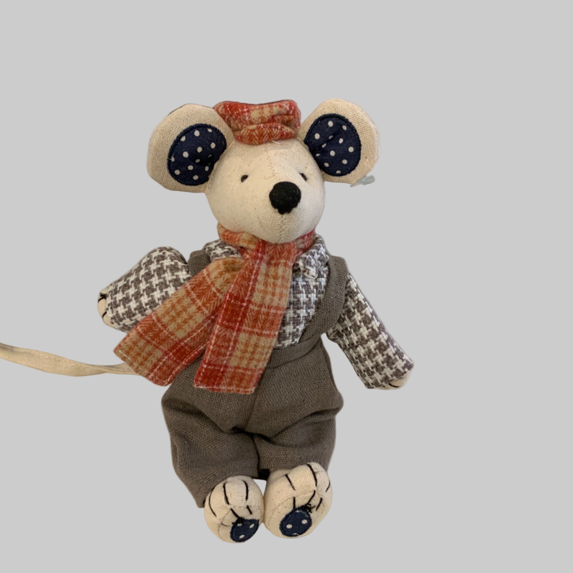 Stuffed toy mouse with a scarf wearing tartan hat and scarf