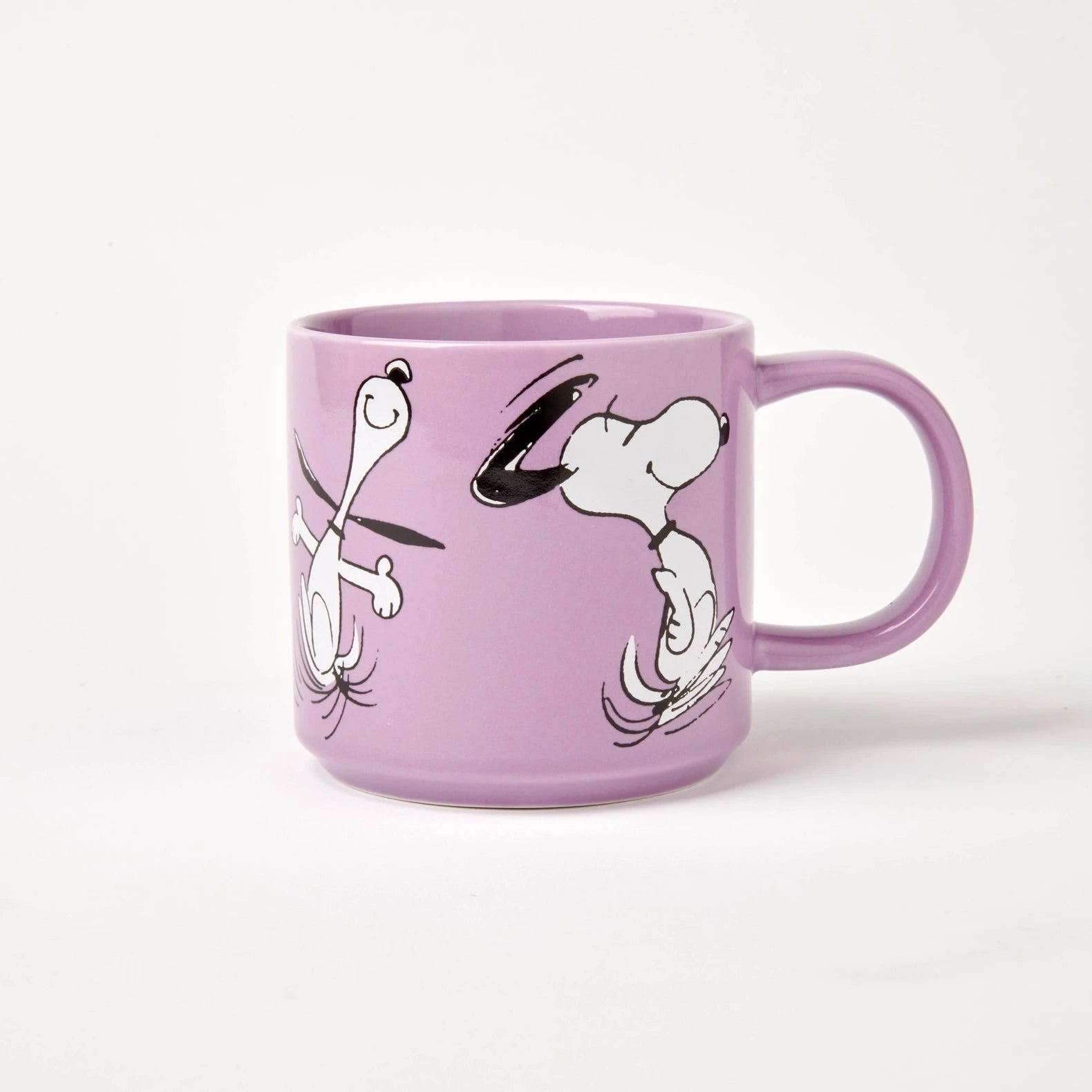 Lilac mug with black and white graphics on a white background