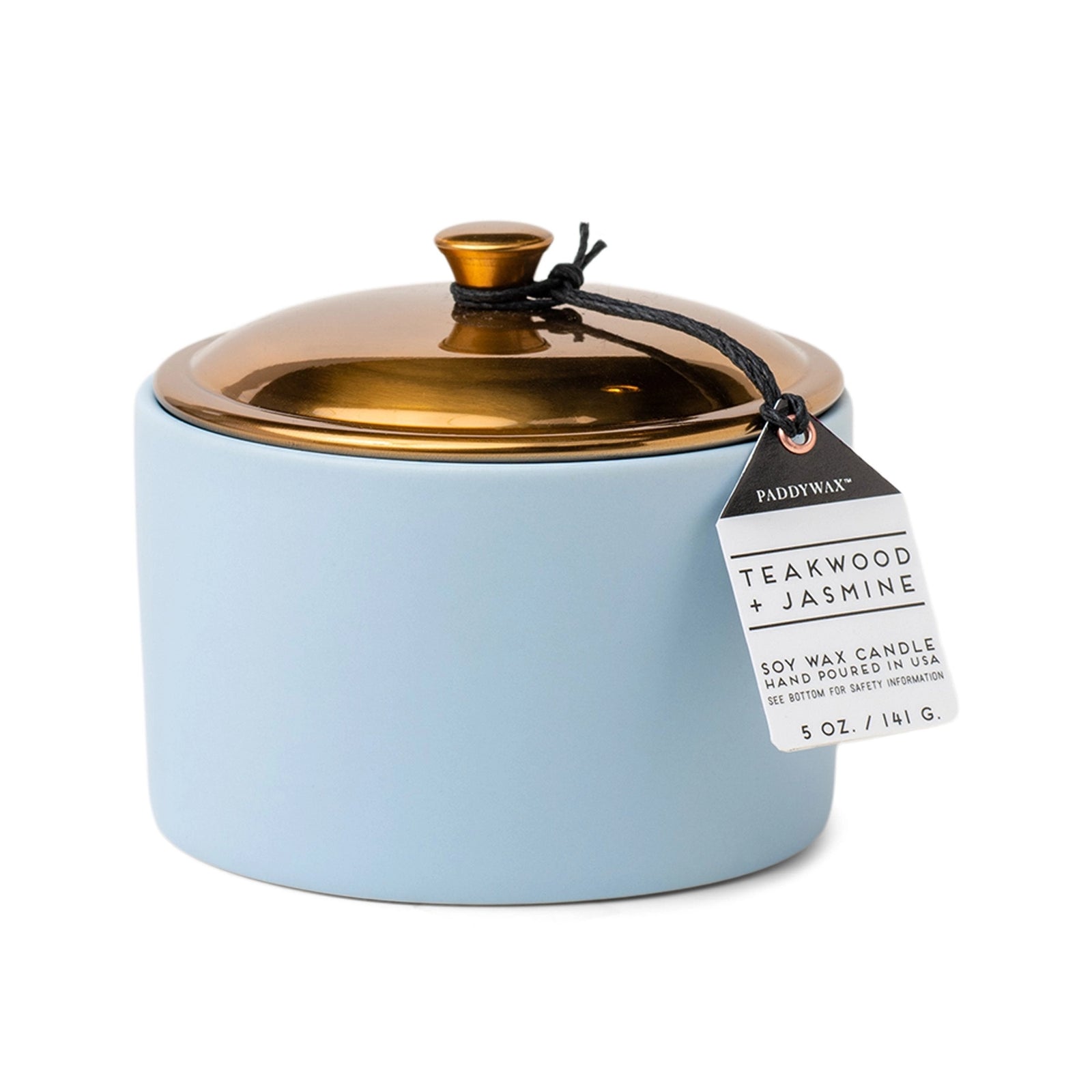 Blue ceramic vessel containing scented candle