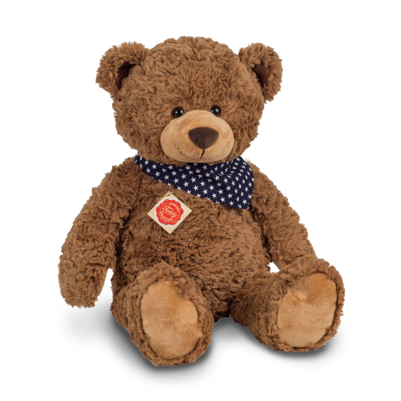 Brown teddy bear with a blue polka dot scarf on a white background